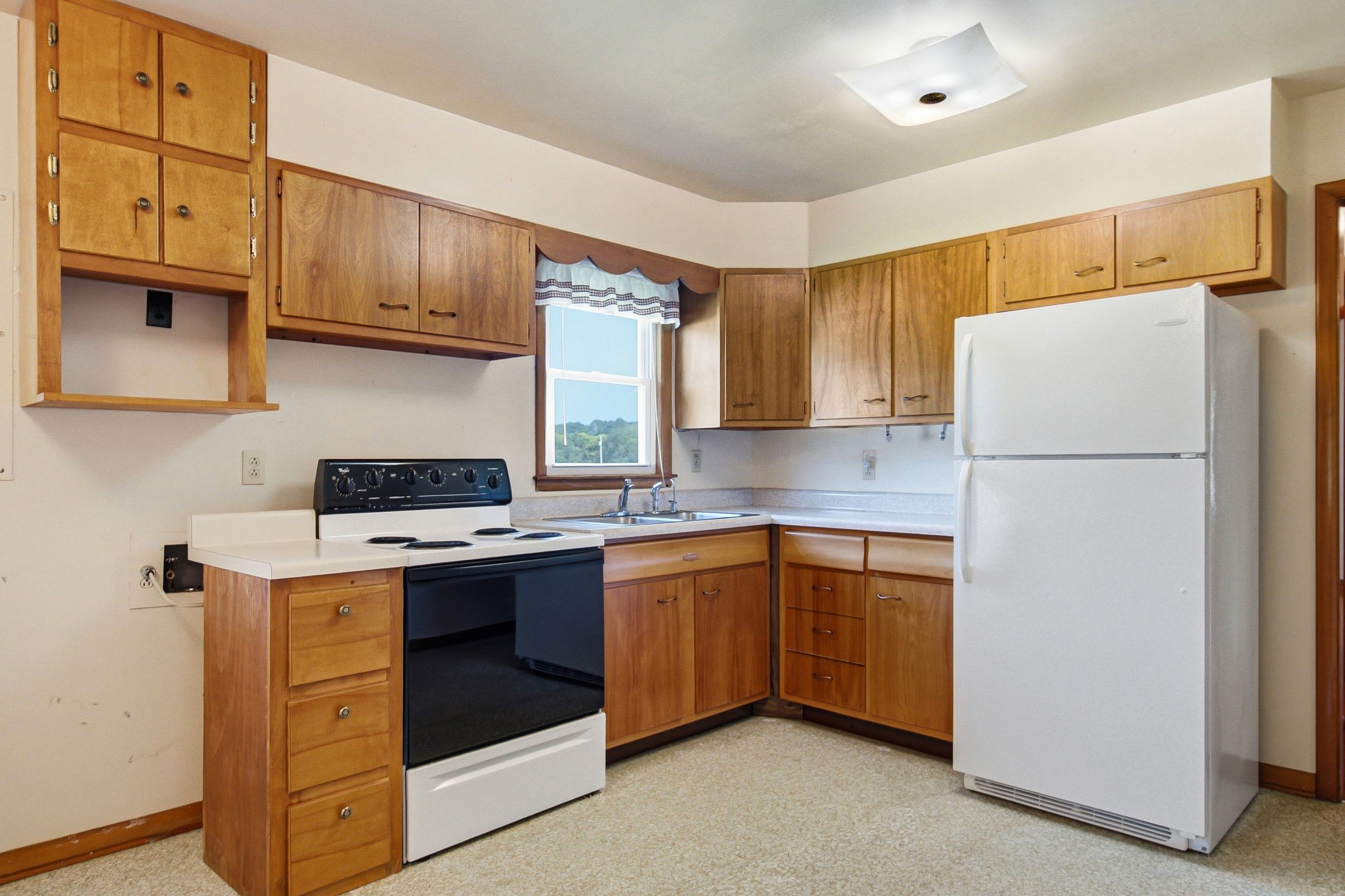 5204 Highway 161 Springfield, TN 37172 - Photo 13 of 40 a kitchen with a sink a refrigerator and cabinets