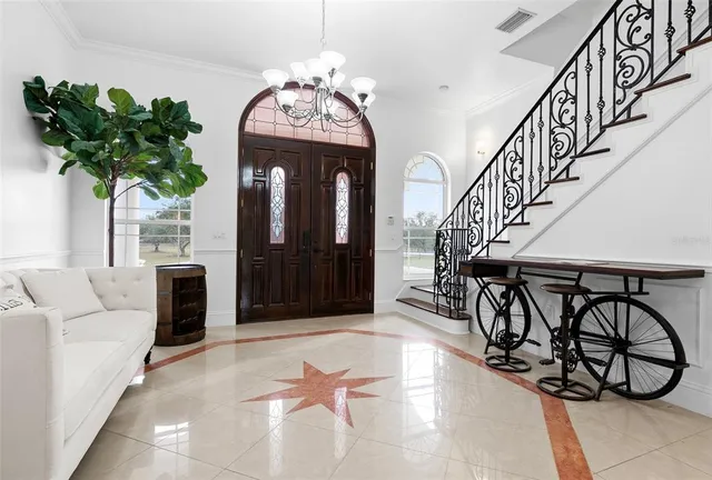 a kitchen with stainless steel appliances granite countertop a refrigerator a stove a sink dishwasher and white cabinets with wooden floor