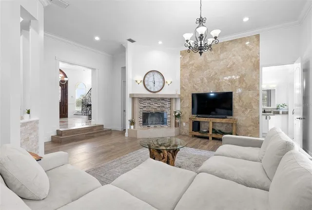 a living room with furniture and a chandelier