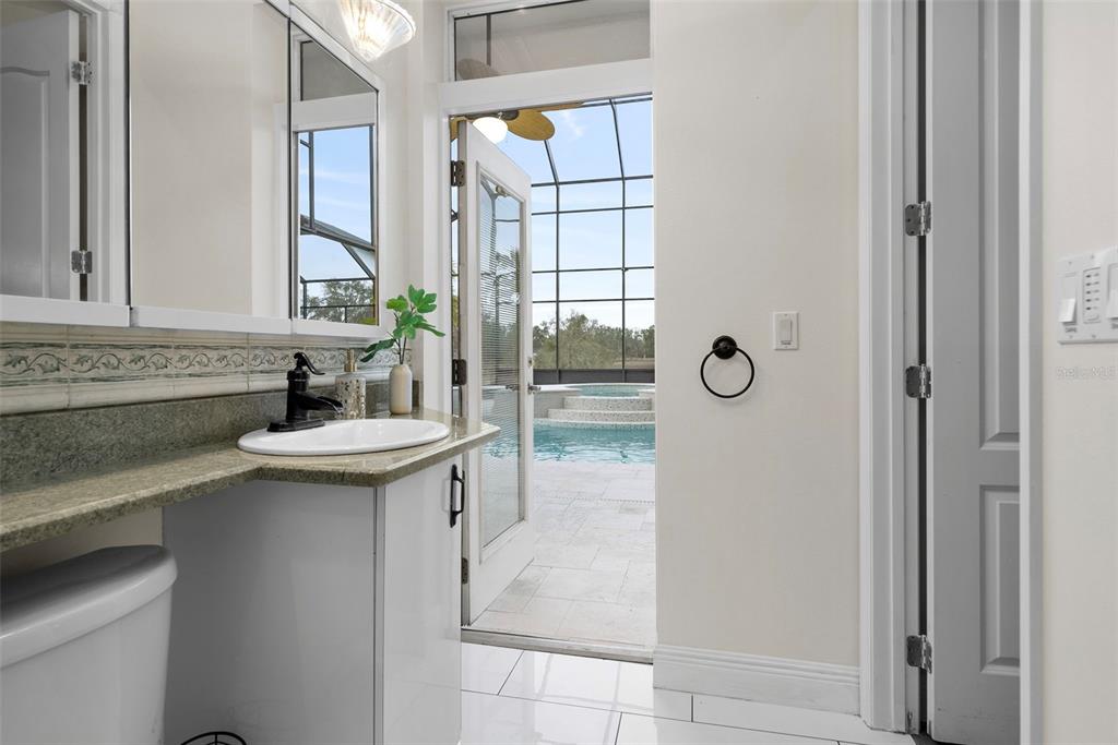 1450 Bern Creek Loop Sarasota, FL 34240 - Photo 19 of 95 a bathroom with a sink and mirror with shower