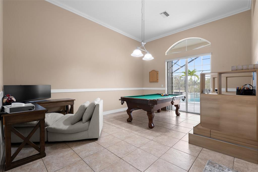 1450 Bern Creek Loop Sarasota, FL 34240 - Photo 54 of 95 a living room with furniture and a flat screen tv