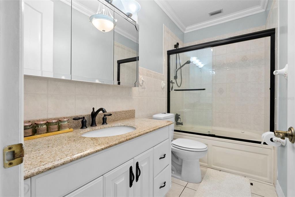 1450 Bern Creek Loop Sarasota, FL 34240 - Photo 57 of 95 a bathroom with a granite countertop sink mirror vanity and toilet