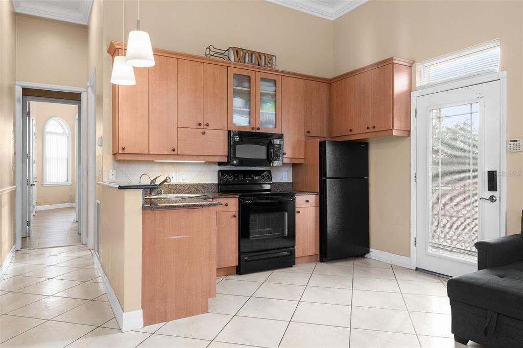 1450 Bern Creek Loop Sarasota, FL 34240 - Photo 59 of 95 a kitchen with stainless steel appliances granite countertop a refrigerator and a stove top oven