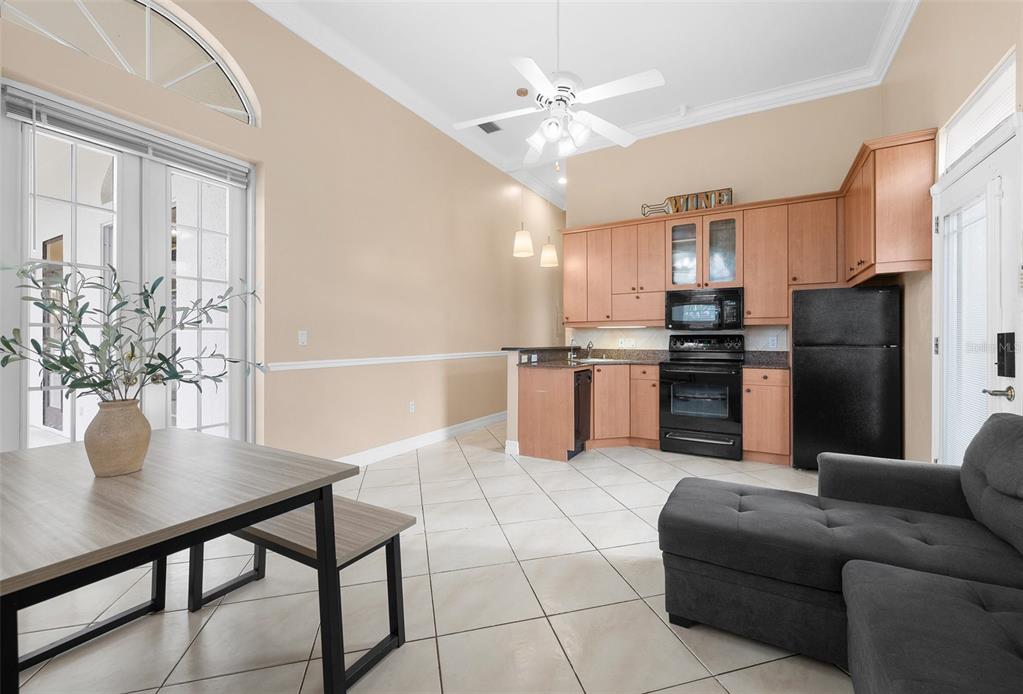 1450 Bern Creek Loop Sarasota, FL 34240 - Photo 60 of 95 a kitchen with stainless steel appliances granite countertop a refrigerator a stove a sink dishwasher and white cabinets with wooden floor