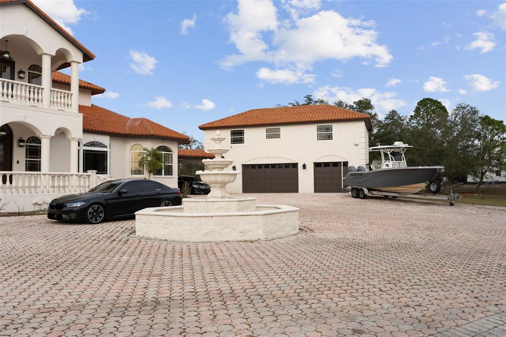 1450 Bern Creek Loop Sarasota, FL 34240 - Photo 6 of 95 a view of a white house with a yard