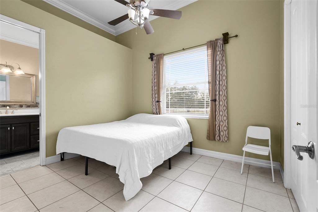 1450 Bern Creek Loop Sarasota, FL 34240 - Photo 62 of 95 a bedroom with a bed and a chandelier