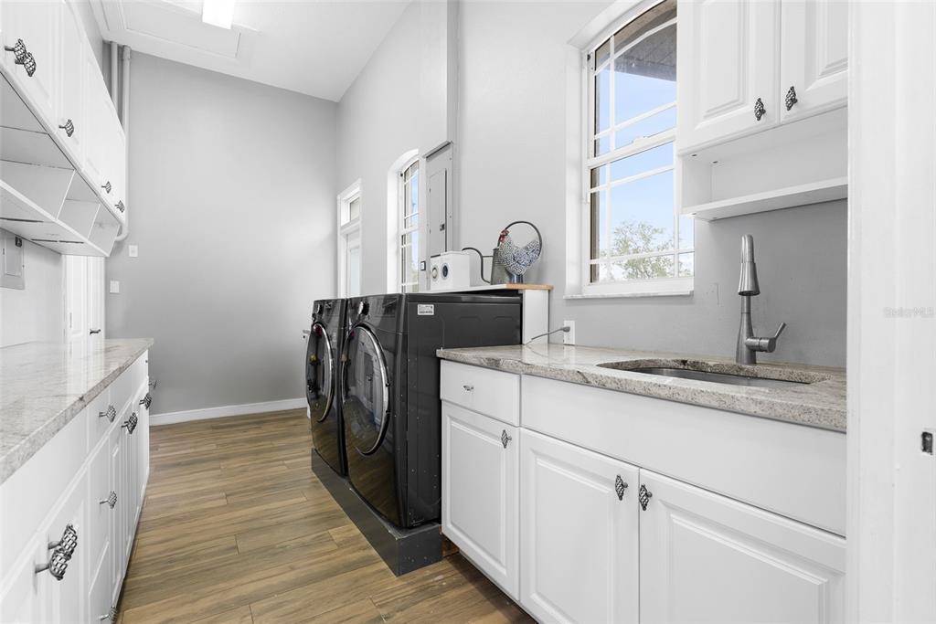 1450 Bern Creek Loop Sarasota, FL 34240 - Photo 66 of 95 a kitchen with granite countertop a sink and a stove top oven