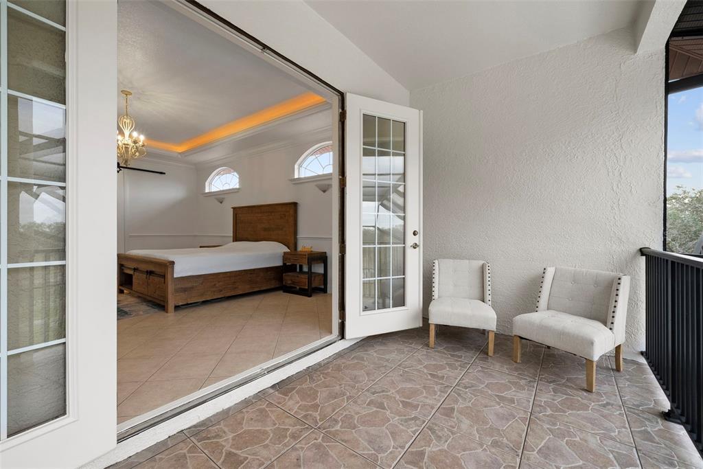 1450 Bern Creek Loop Sarasota, FL 34240 - Photo 76 of 95 a spacious bedroom with a bed and a couch