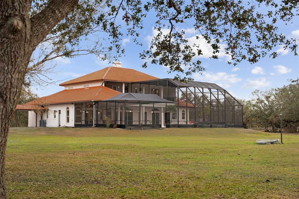 1450 Bern Creek Loop Sarasota, FL 34240 - Photo 91 of 95 a view of a house next to a big yard with large trees