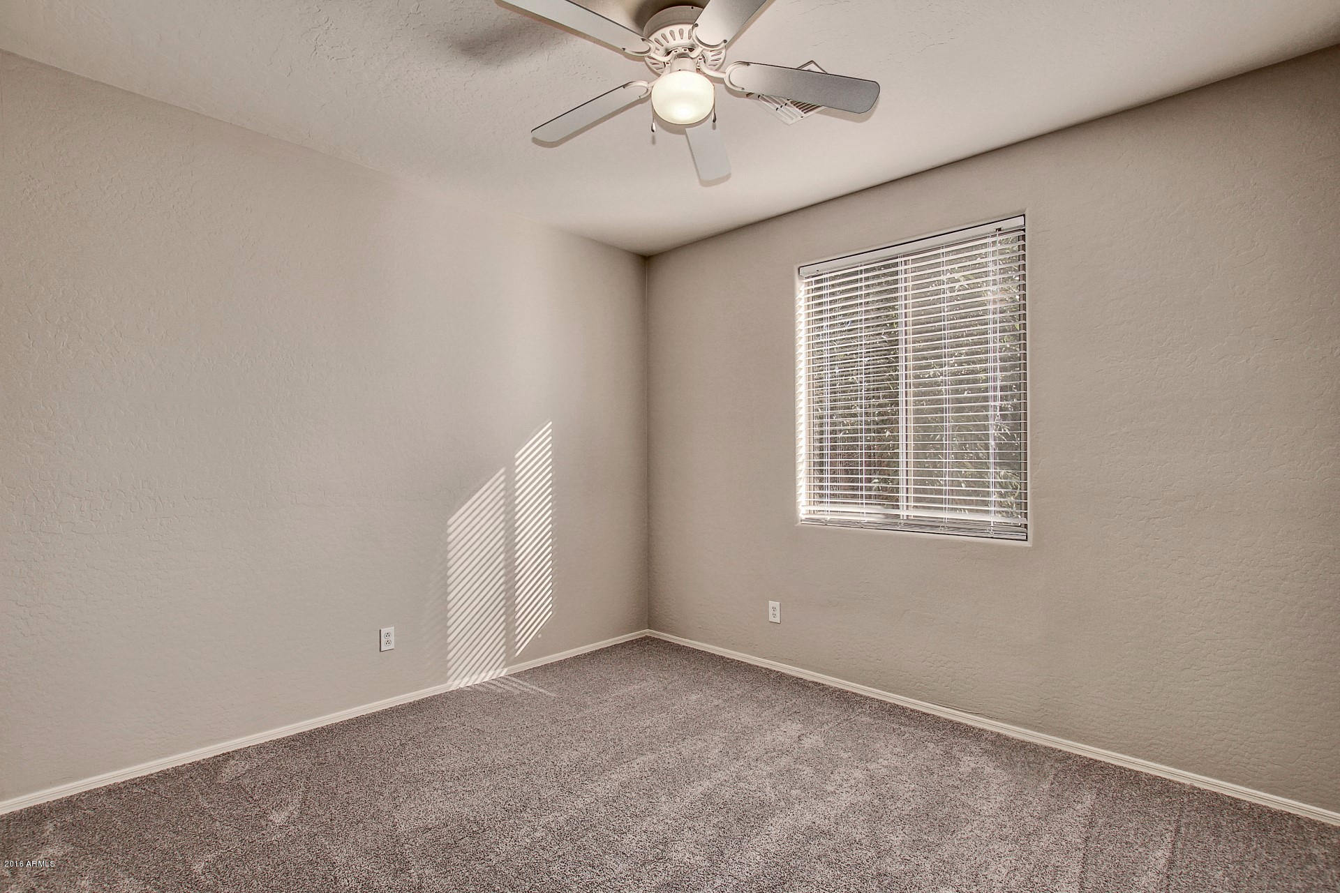 1360 East Harrison Street Gilbert, AZ 85295 - Photo 26 of 34 an empty room with a window and a fan