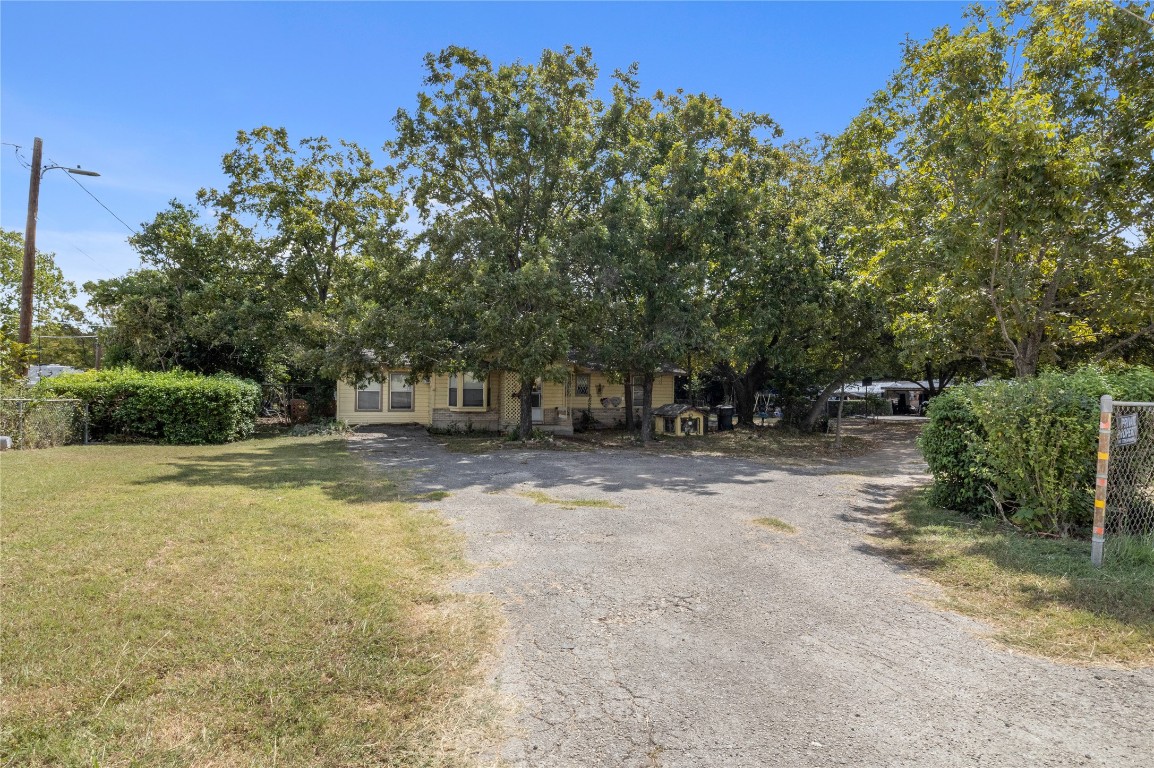 1322 North Interstate 35 San Marcos, TX 78666 - Photo 5 of 22 a view of a yard with plants and trees