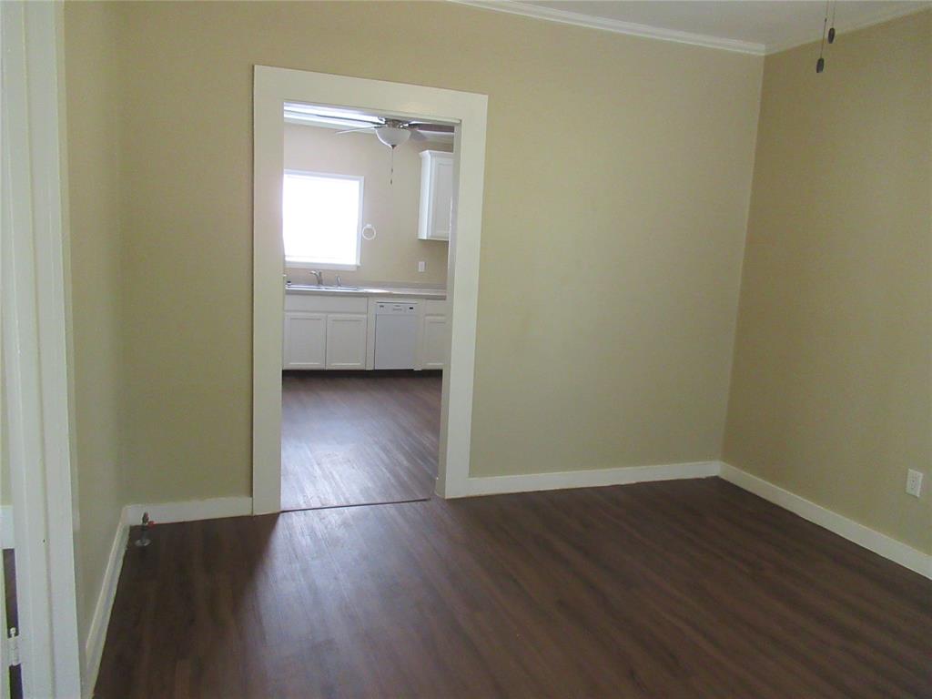 1402 Walnut Street Commerce, TX 75428 - Photo 10 of 12 a view of a room with wooden floor and a window