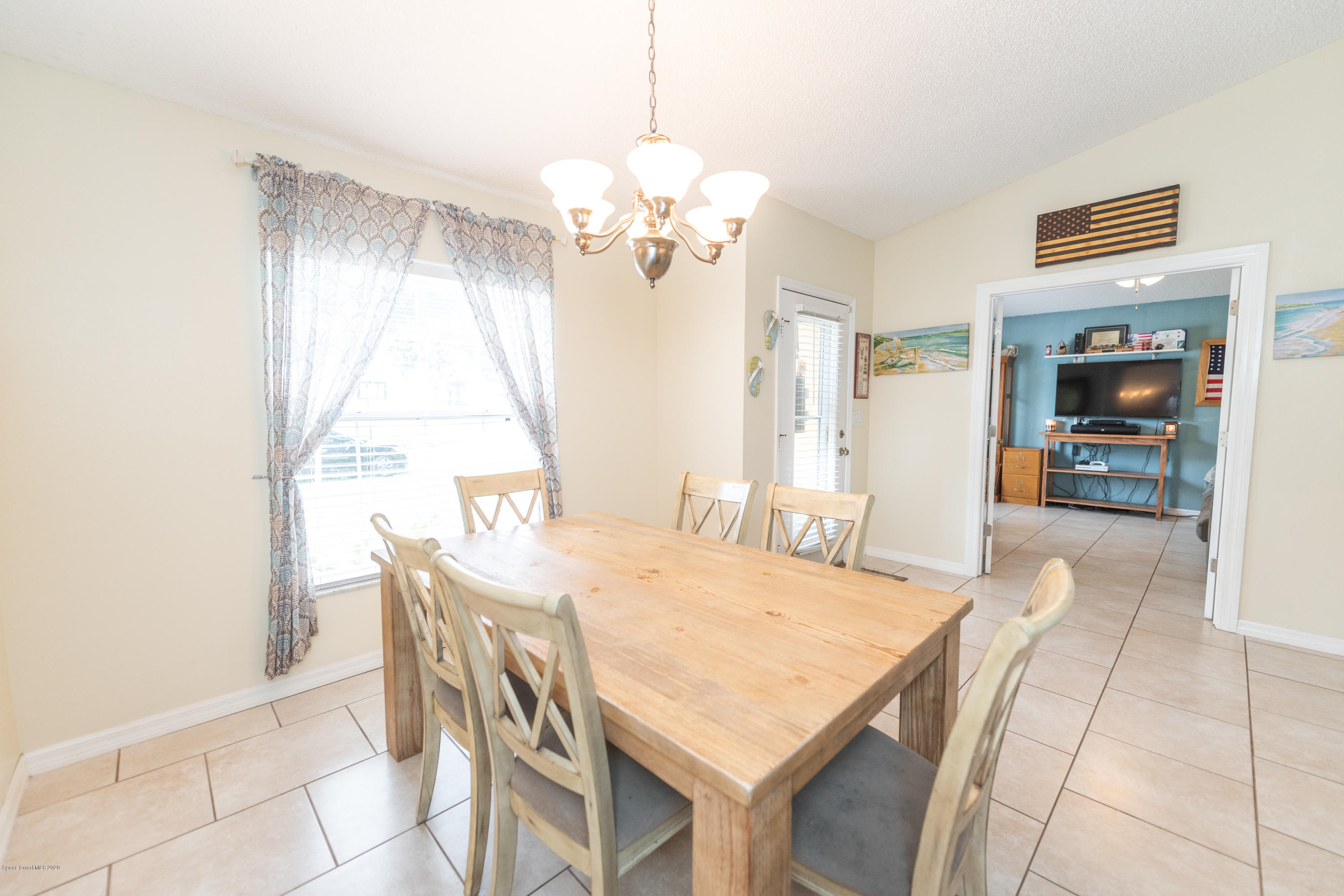 6040 Adina Road Cocoa, FL 32927 - Photo 3 of 23 a view of a dining room with furniture and a chandelier