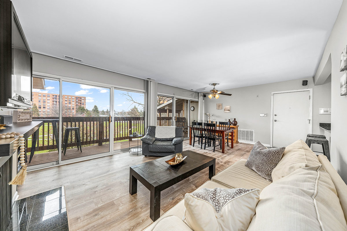 5852 Forest View Road, Unit E Lisle, IL 60532 - Photo 8 of 21 a living room with furniture and a wooden floor