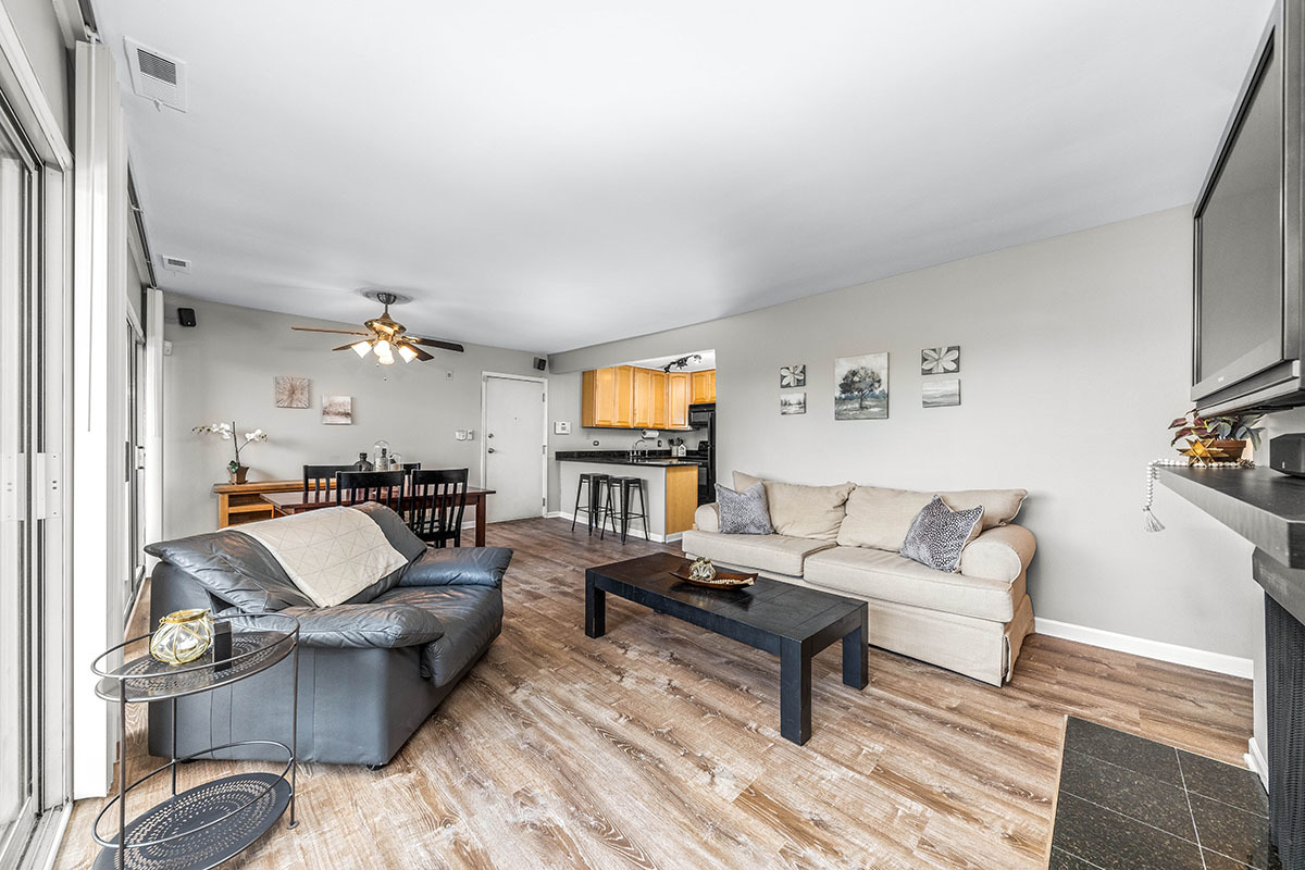 5852 Forest View Road, Unit E Lisle, IL 60532 - Photo 9 of 21 a living room with furniture and a flat screen tv