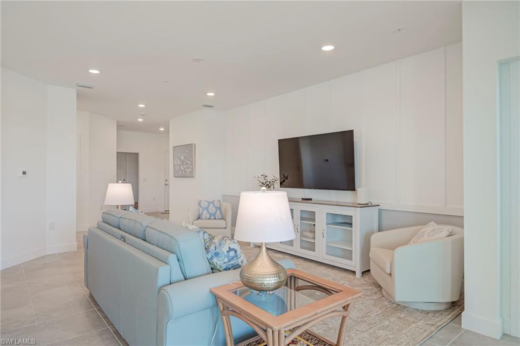 5686 Mayflower Way, Unit 702 Ave Maria, FL 34142 - Photo 11 of 50 Family area with recessed lighting , Convenient Floor outlet, & decorative wood accent wall