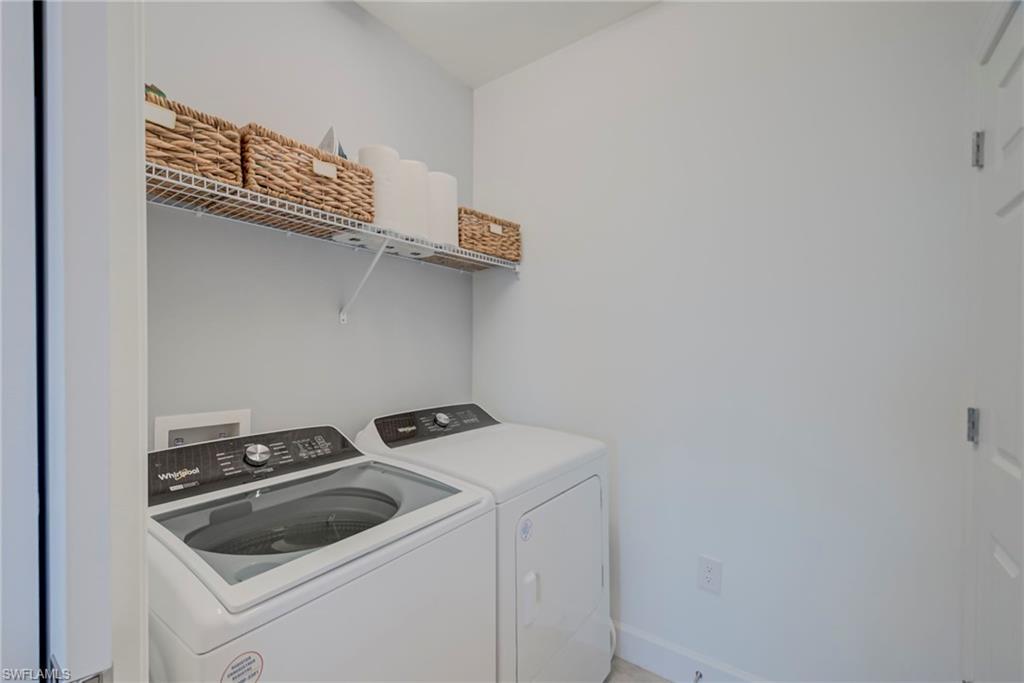 5686 Mayflower Way, Unit 702 Ave Maria, FL 34142 - Photo 21 of 50 Laundry area w/pocket slider featuring separate washer and dryer