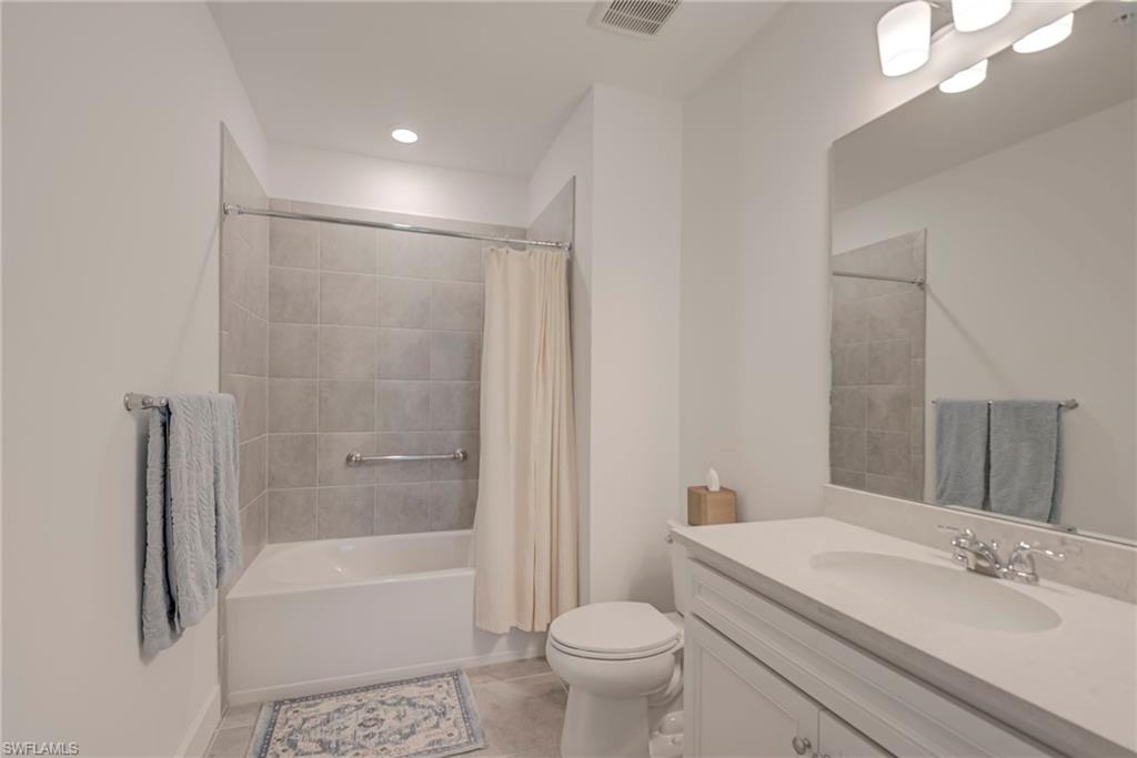 5686 Mayflower Way, Unit 702 Ave Maria, FL 34142 - Photo 23 of 50 Bathroom with vanity, light tile flooring, and shower / bath combo