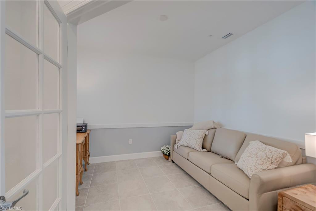 5686 Mayflower Way, Unit 702 Ave Maria, FL 34142 - Photo 24 of 50 Home office/flex room featuring detailed ceiling an wainscoting (by builder) with plantation shutters and glass french doors!