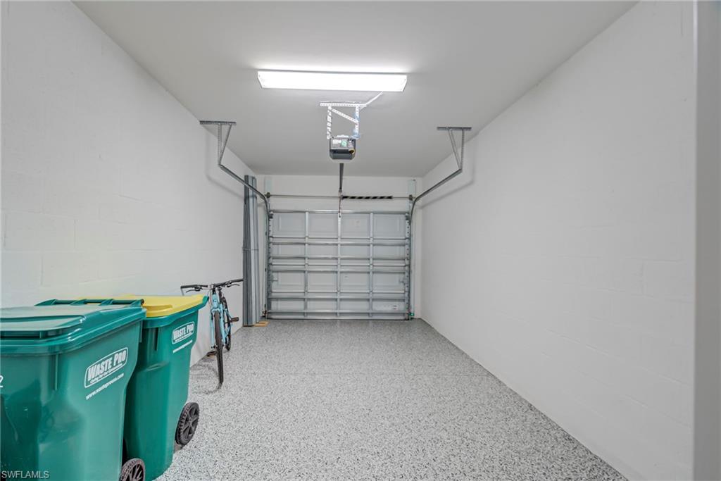 5686 Mayflower Way, Unit 702 Ave Maria, FL 34142 - Photo 25 of 50 1 C Garage featuring Epoxy flooring, concrete block wall & garage door opener