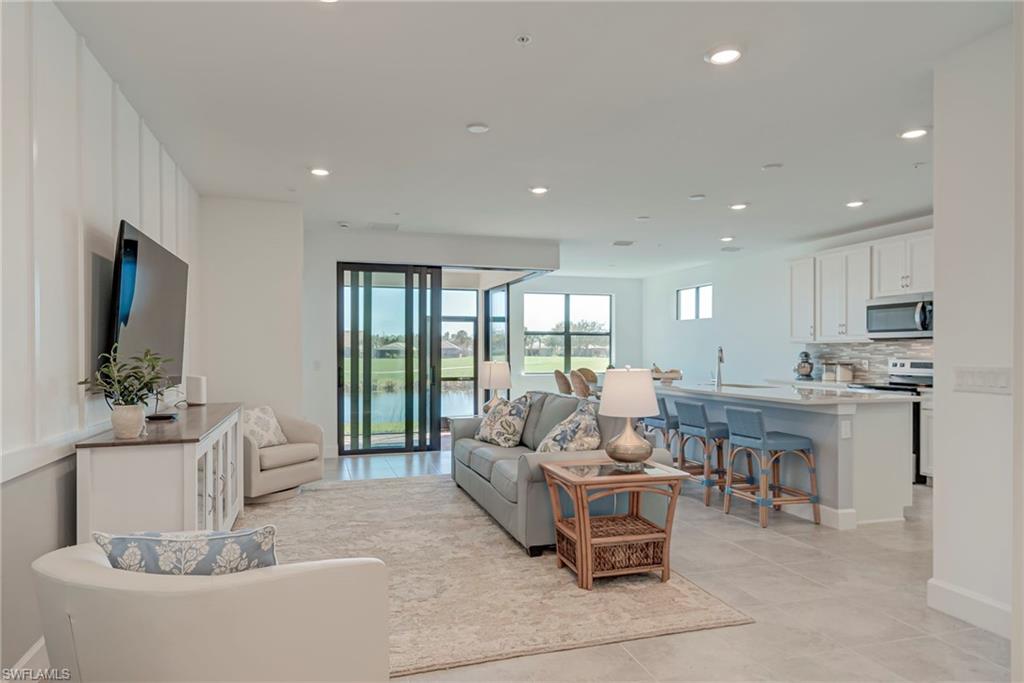 5686 Mayflower Way, Unit 702 Ave Maria, FL 34142 - Photo 8 of 50 Family room featuring recessed lighting and zero corner entry doors