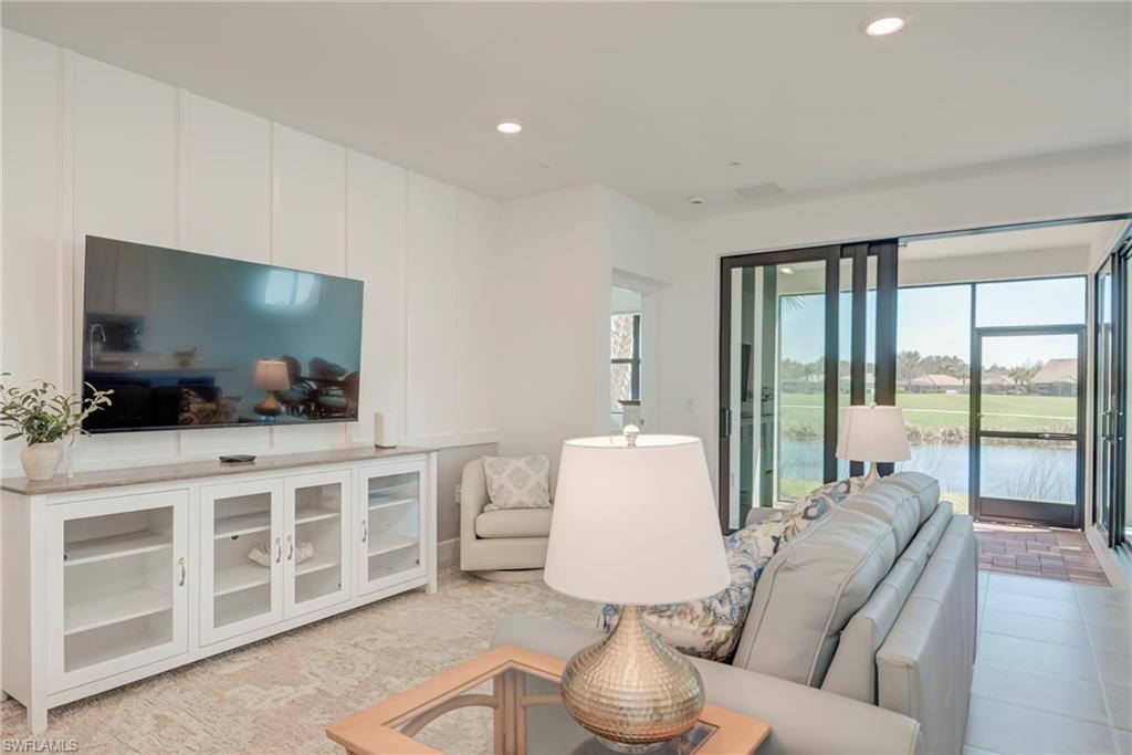 5686 Mayflower Way, Unit 702 Ave Maria, FL 34142 - Photo 9 of 50 Family room featuring recessed lighting and a water view
