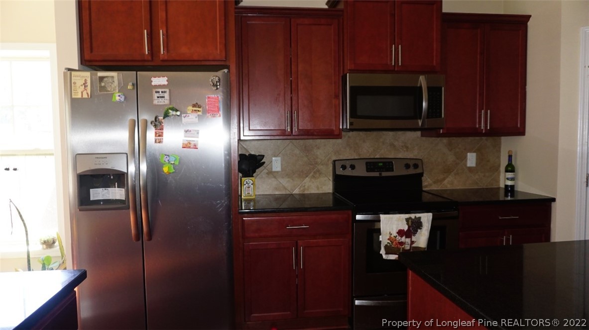 115 Shellbark Drive Spring Lake, NC 28390 - Photo 11 of 30 a kitchen with stainless steel appliances granite countertop a refrigerator and a microwave