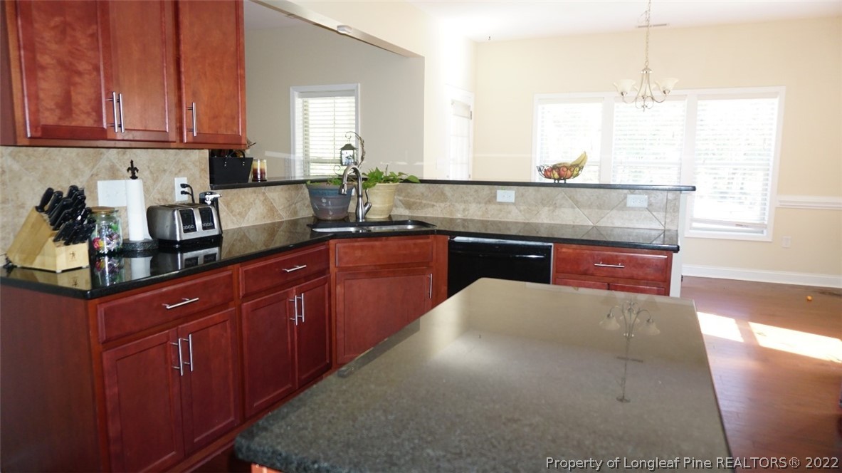 115 Shellbark Drive Spring Lake, NC 28390 - Photo 12 of 30 a kitchen with granite countertop a sink and cabinets