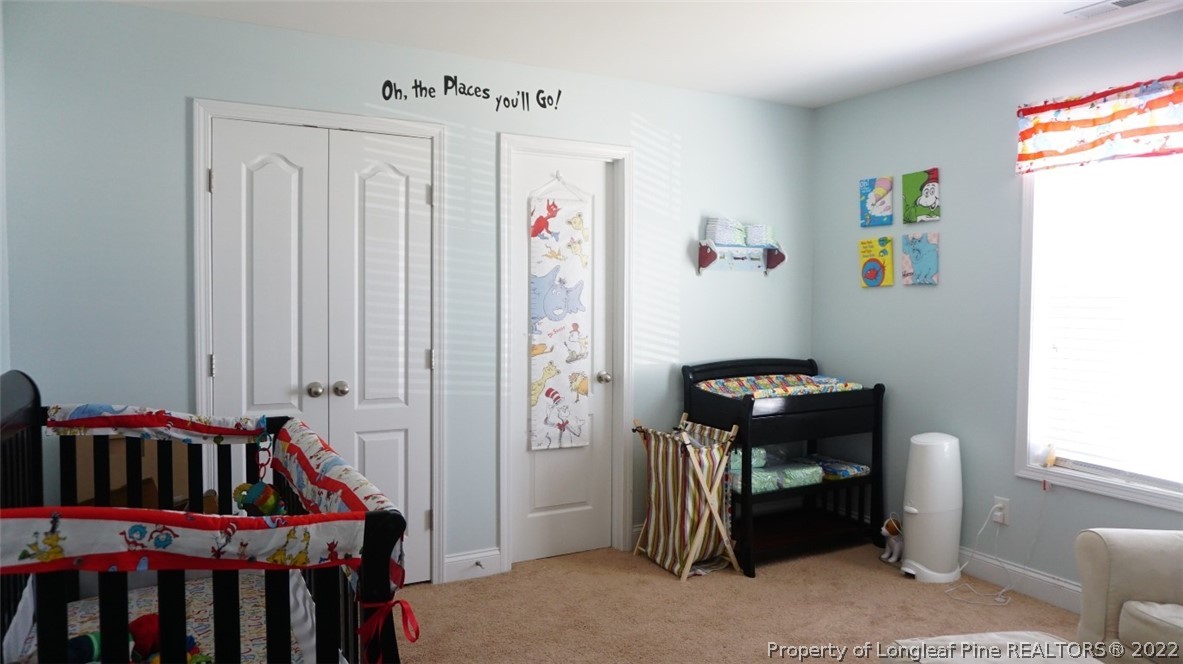 115 Shellbark Drive Spring Lake, NC 28390 - Photo 16 of 30 a bedroom with a bed and a window