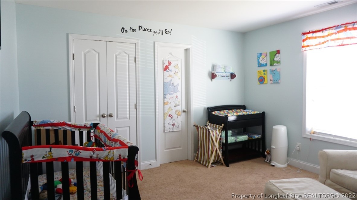 115 Shellbark Drive Spring Lake, NC 28390 - Photo 17 of 30 a bedroom with furniture and baby crib