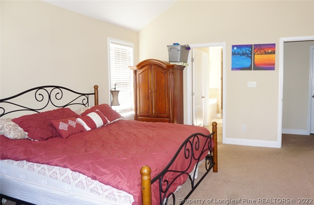 115 Shellbark Drive Spring Lake, NC 28390 - Photo 23 of 30 a bedroom with a bed and a painting on the wall