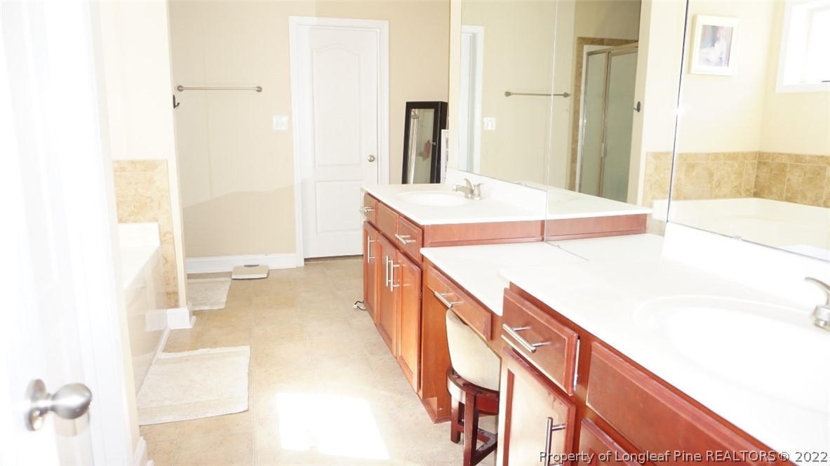 115 Shellbark Drive Spring Lake, NC 28390 - Photo 24 of 30 a bathroom with a sink and a mirror