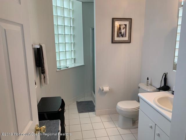 40 Broad Street, Unit 3A Red Bank, NJ 07701 - Photo 6 of 10 a white toilet sitting next to a bathroom sink