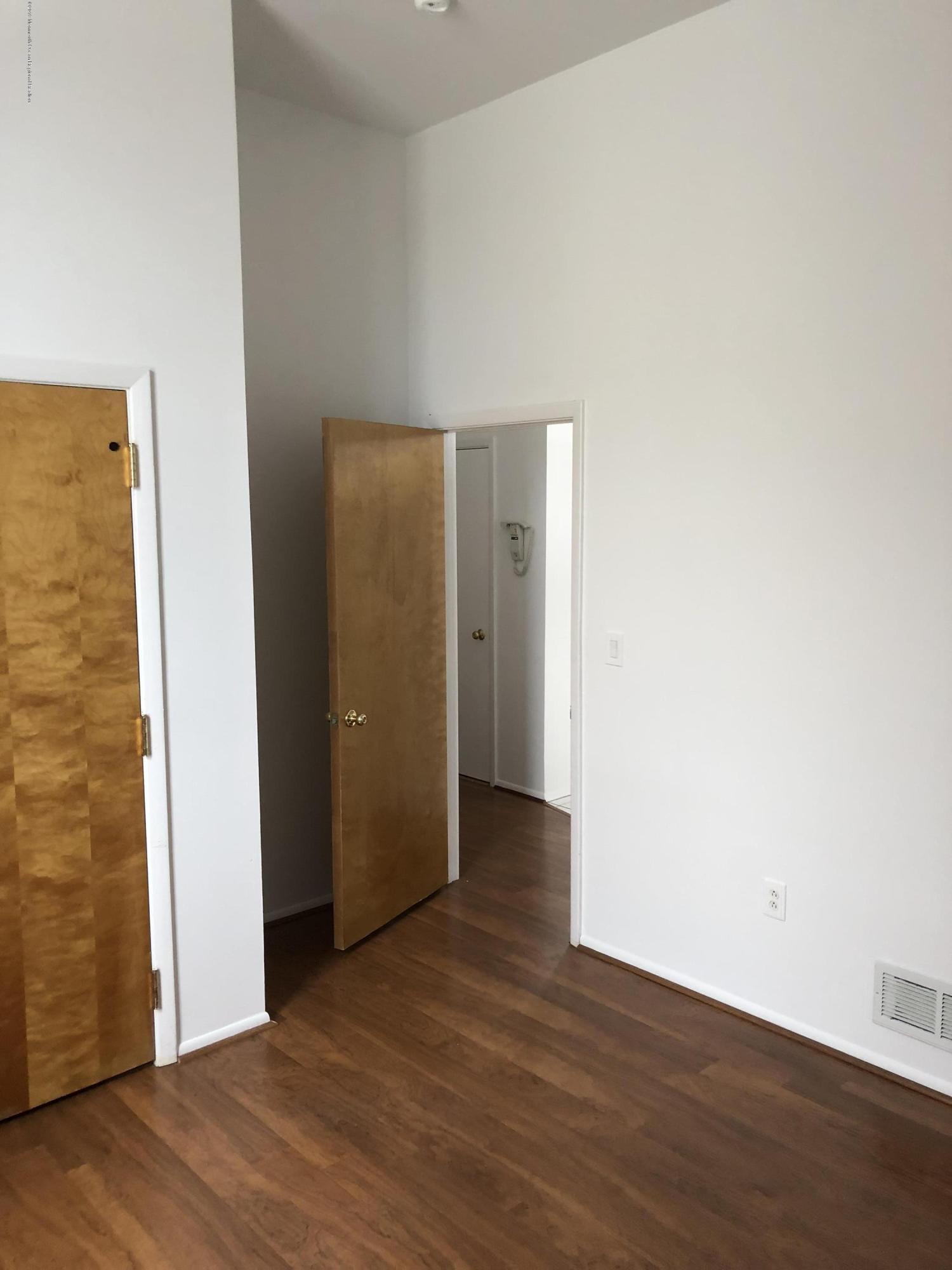 40 Broad Street, Unit 3A Red Bank, NJ 07701 - Photo 8 of 10 an empty room with wooden floor
