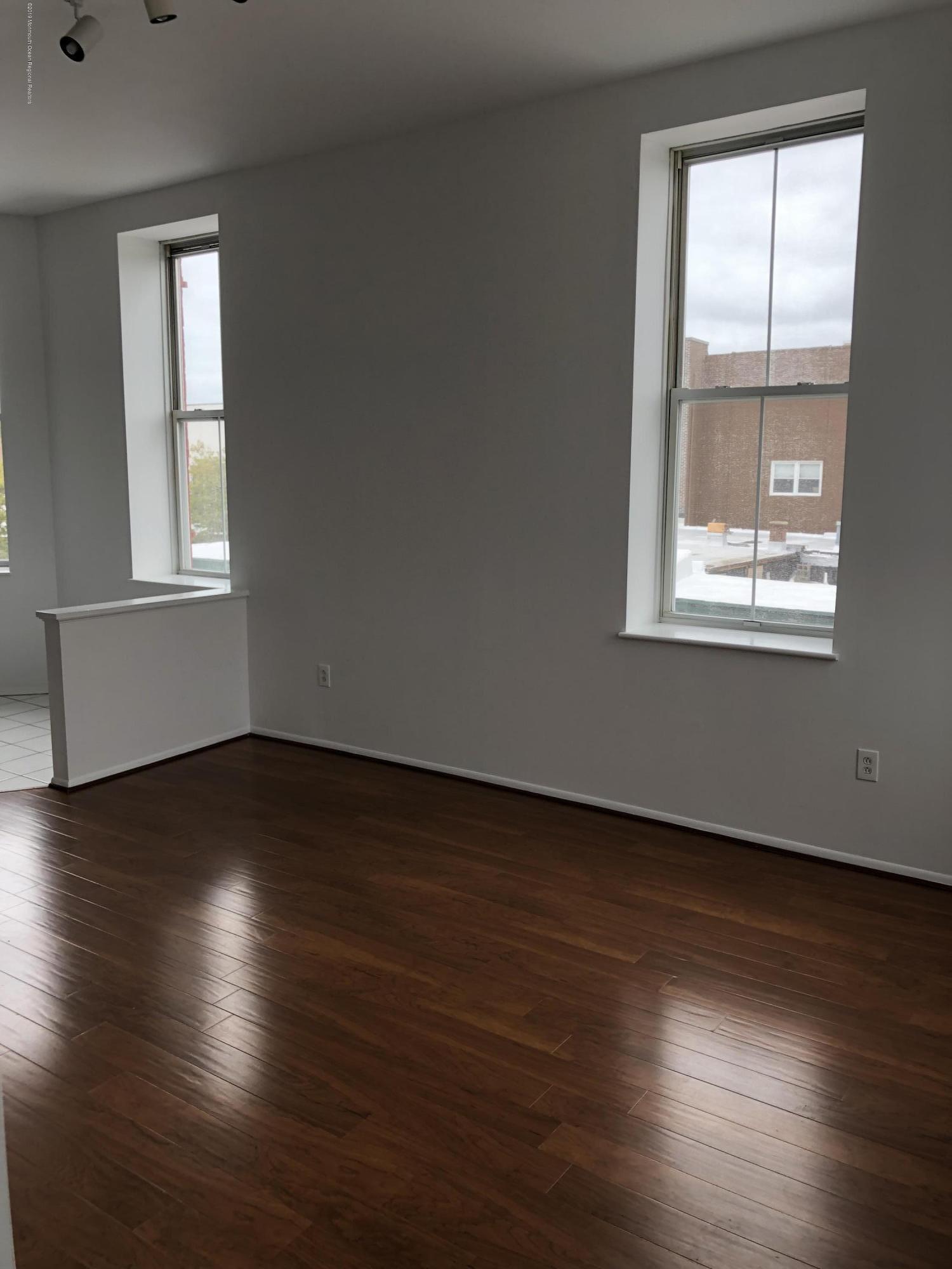 40 Broad Street, Unit 3A Red Bank, NJ 07701 - Photo 10 of 10 an empty room with wooden floor and windows