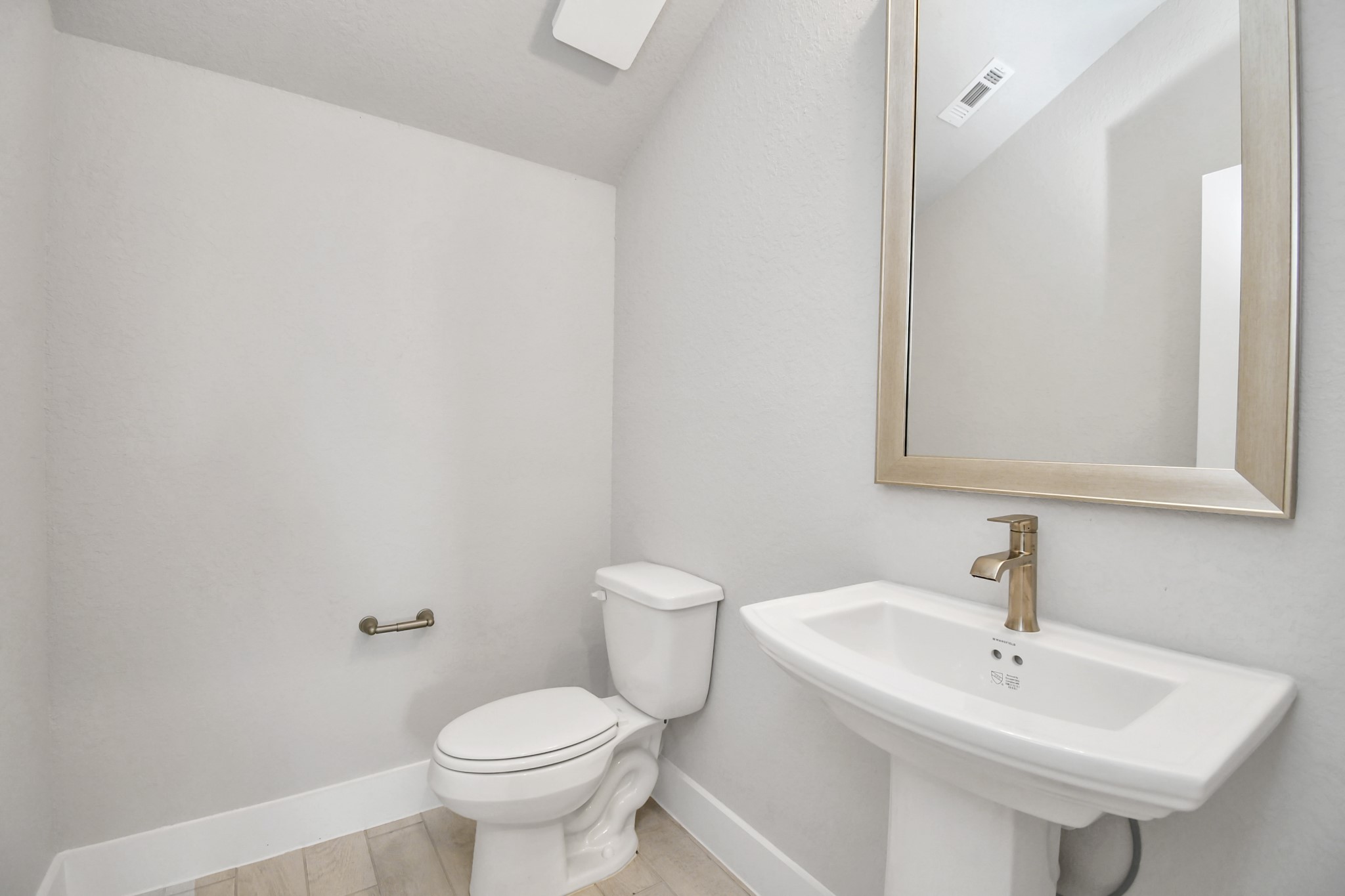 3106 Native Spg Drive Spring, TX 77373 - Photo 8 of 38 This half bathroom features a stylish pedestal sink, modern hardware, and bright recessed lighting, creating a sleek and inviting space. Sample photo of completed home with similar floor plan. Actual colors and selections may vary.