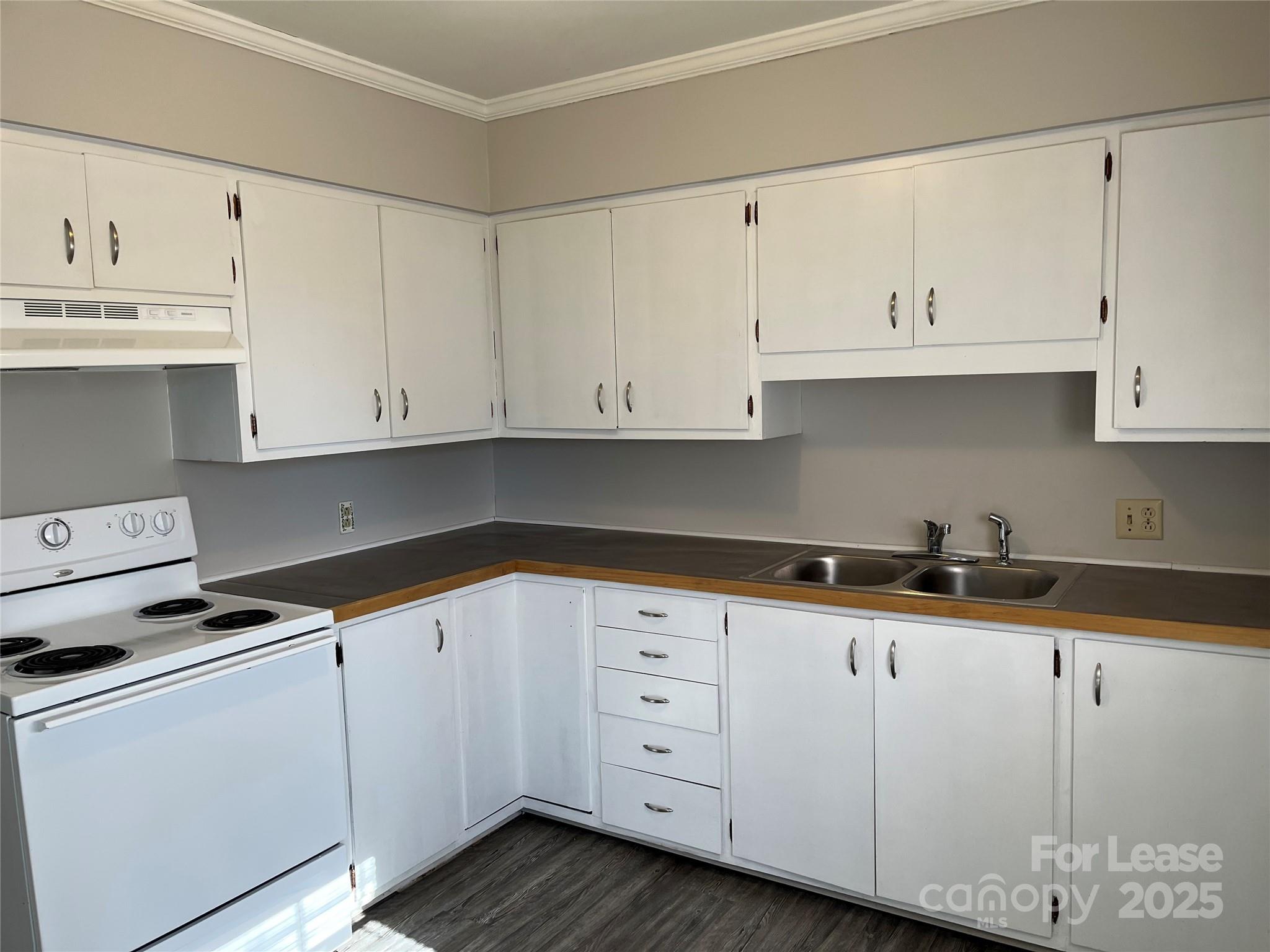 600 Montgomery Avenue, Unit 3 Albemarle, NC 28001 - Photo 4 of 9 a kitchen with granite countertop white cabinets and white appliances