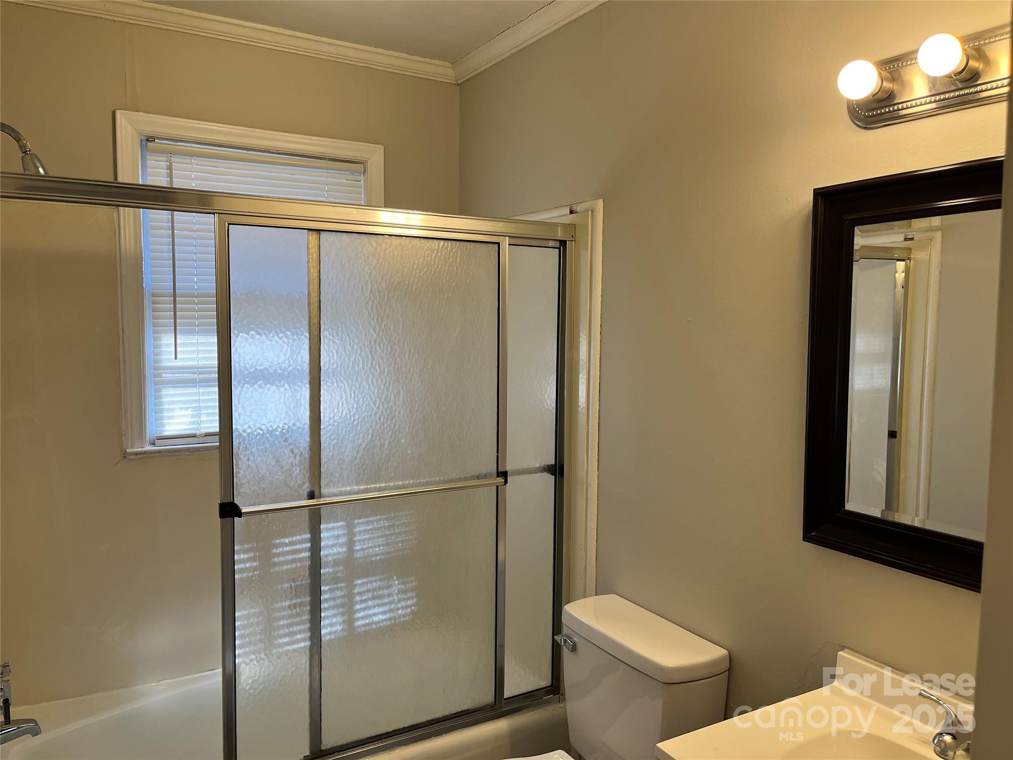 600 Montgomery Avenue, Unit 3 Albemarle, NC 28001 - Photo 8 of 9 a bathroom with a toilet and a shower