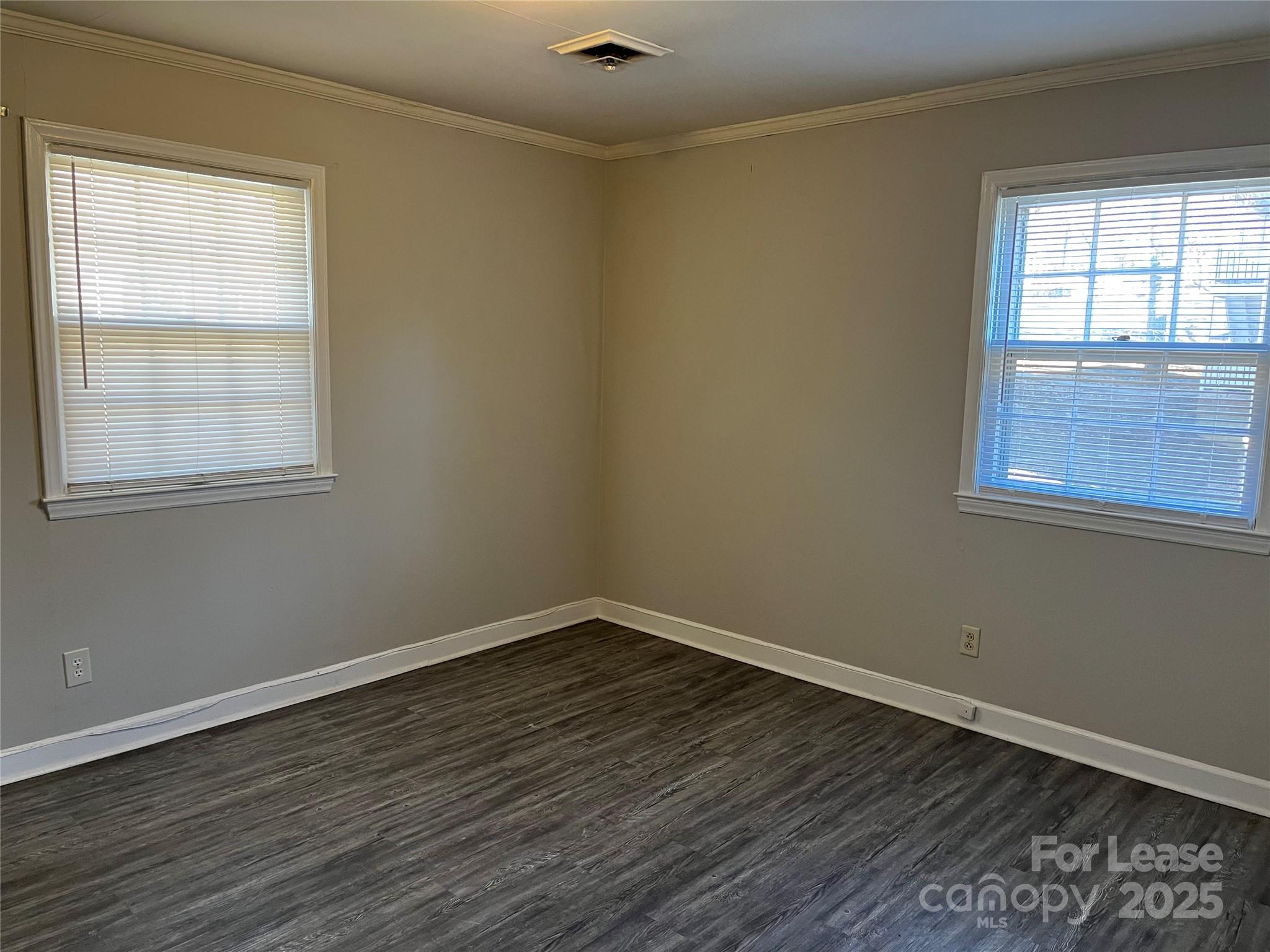600 Montgomery Avenue, Unit 3 Albemarle, NC 28001 - Photo 9 of 9 a view of an empty room with wooden floor and a window