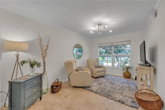 a living room with furniture a couch and a mirror