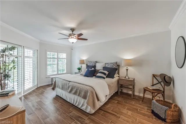a bed room with a bed a television and a large window