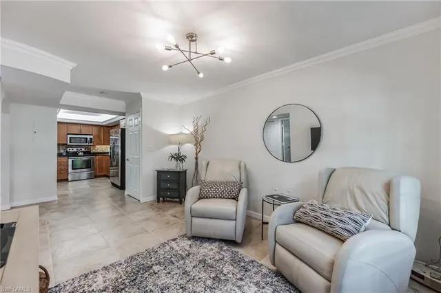 a living room with furniture a dining table and a potted plant