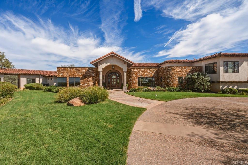 20655 Sutherland Dam Road Ramona, CA 92065 - Photo 13 of 73 a front view of a house with a yard and garage