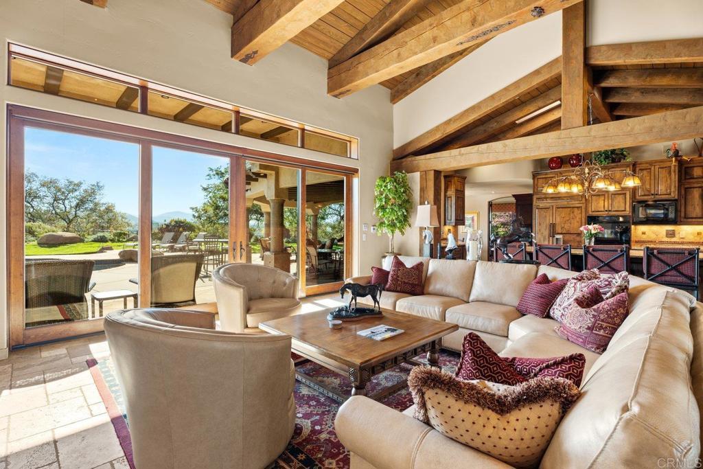 20655 Sutherland Dam Road Ramona, CA 92065 - Photo 24 of 73 a living room with furniture a fireplace and a large window