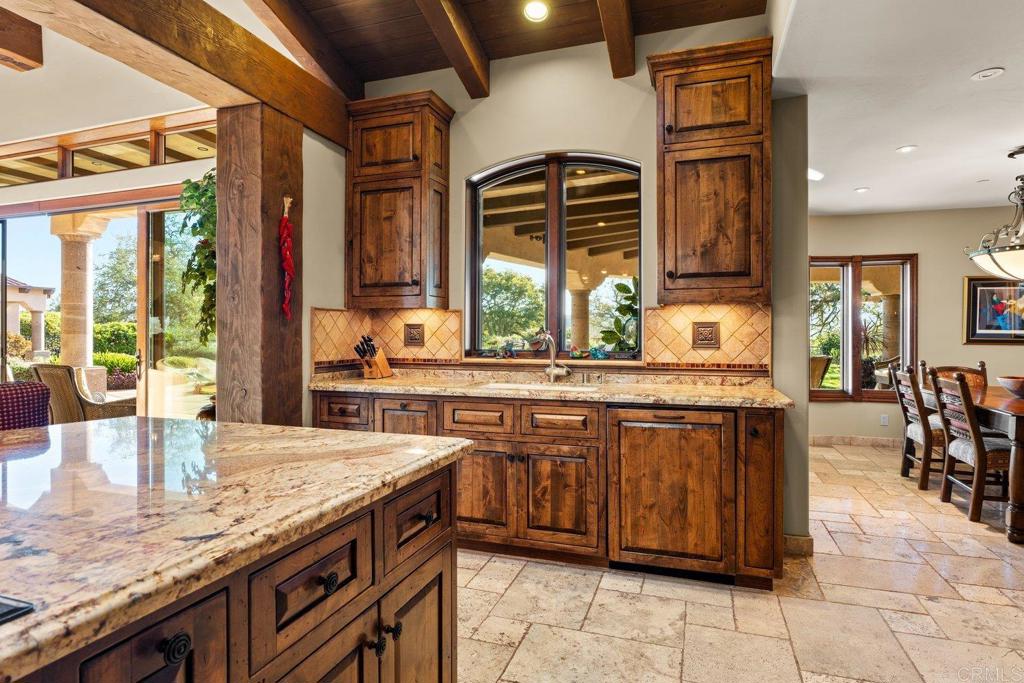 20655 Sutherland Dam Road Ramona, CA 92065 - Photo 33 of 73 a kitchen with stainless steel appliances granite countertop a sink a stove and a wooden cabinets