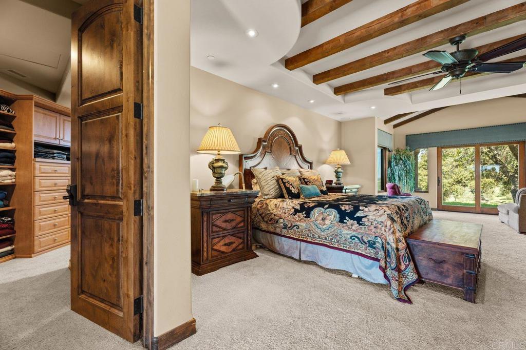 20655 Sutherland Dam Road Ramona, CA 92065 - Photo 37 of 73 a bed room with a bed and a mirror