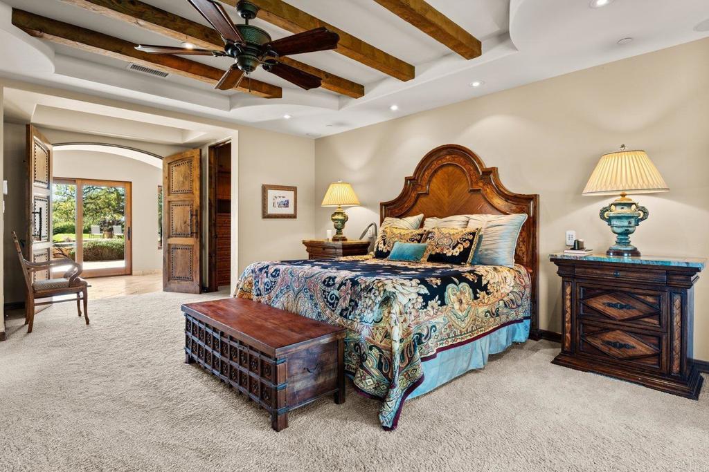 20655 Sutherland Dam Road Ramona, CA 92065 - Photo 39 of 73 a bedroom with a bed and a chandelier