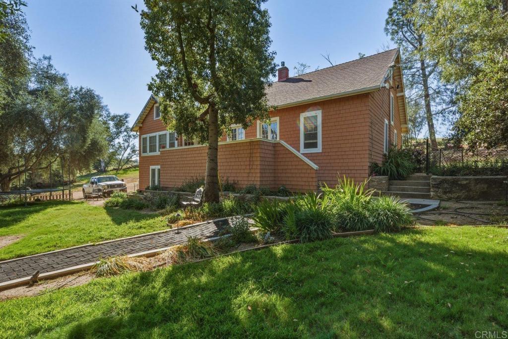20655 Sutherland Dam Road Ramona, CA 92065 - Photo 56 of 73 a backyard of a house with plants and large tree