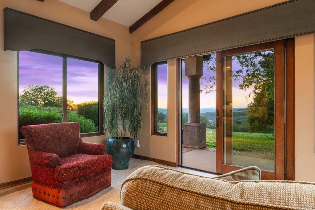20655 Sutherland Dam Road Ramona, CA 92065 - Photo 68 of 73 a living room with patio furniture and a floor to ceiling window
