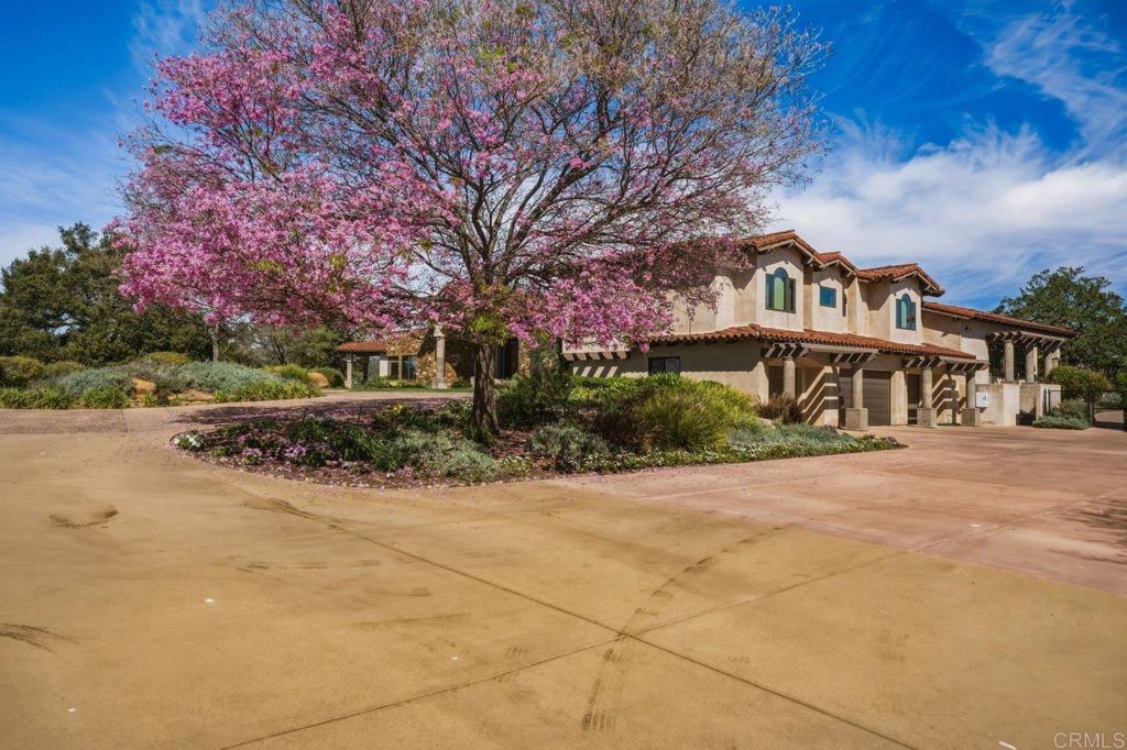 20655 Sutherland Dam Road Ramona, CA 92065 - Photo 8 of 73 a front view of a house with a yard and potted plants